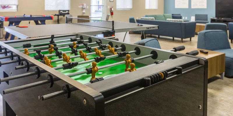 Recreation room with foosball, ping pong, and lounge seating.