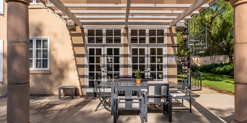 Outdoor patio with pergola and seating.