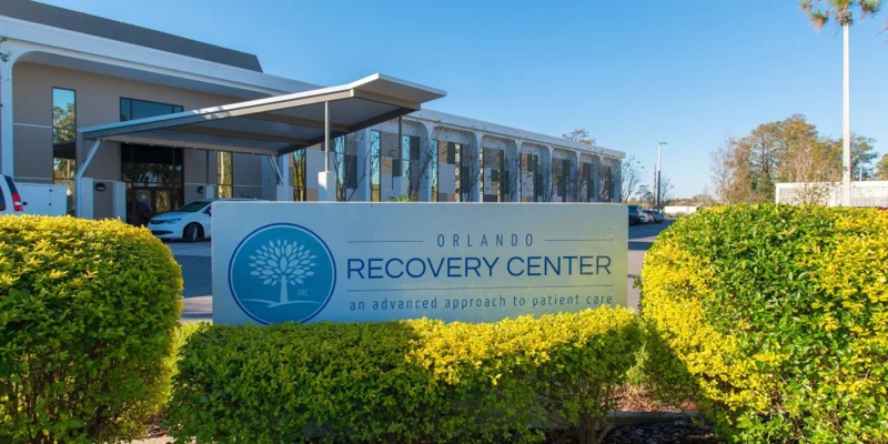 Exterior of Orlando Recovery Center with a welcoming sign and landscaping.