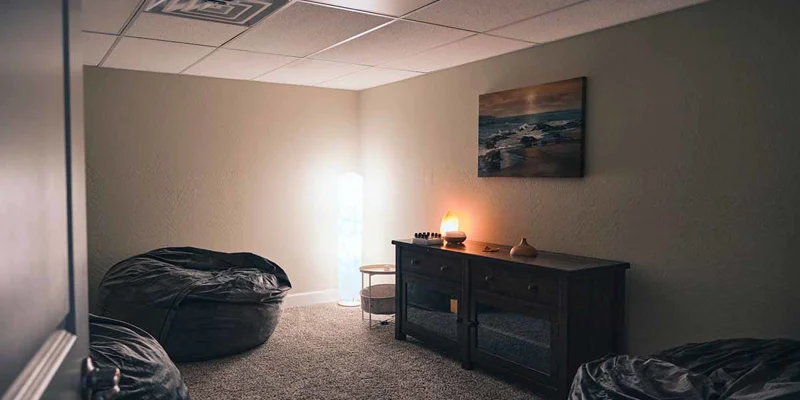 Cozy relaxation room with bean bags and dim lighting.
