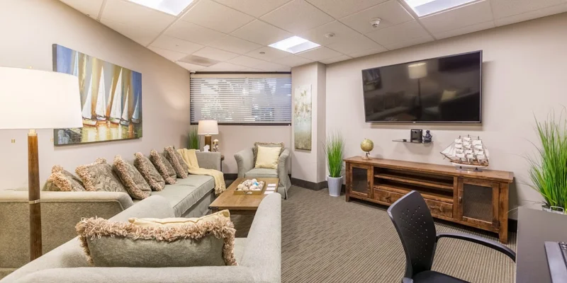 A cozy lounge with sofas, a TV, and nautical-themed décor