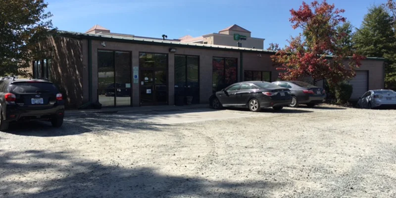Facility parking with entrance in view.