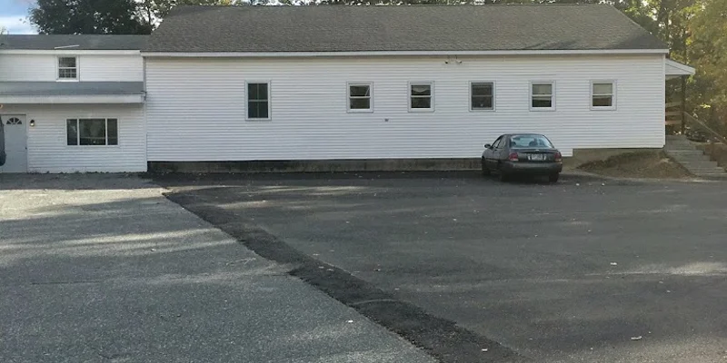 Facility exterior with parking and stairway to entrance.