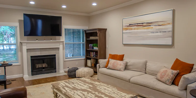 Living room with a fireplace, sofas, and a TV.