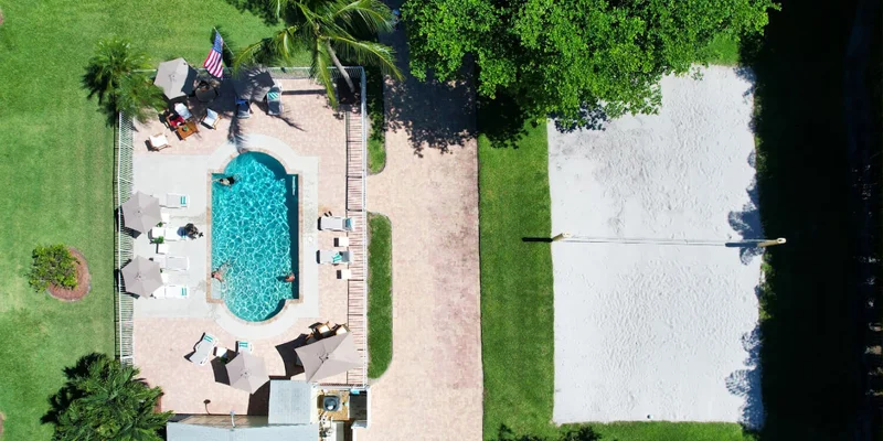 Aerial view of pool and sand volleyball court.