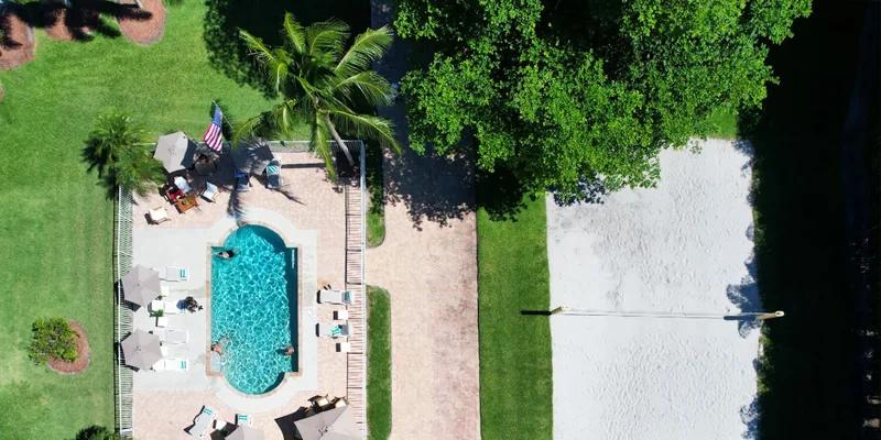 Aerial view of pool and sand volleyball court.