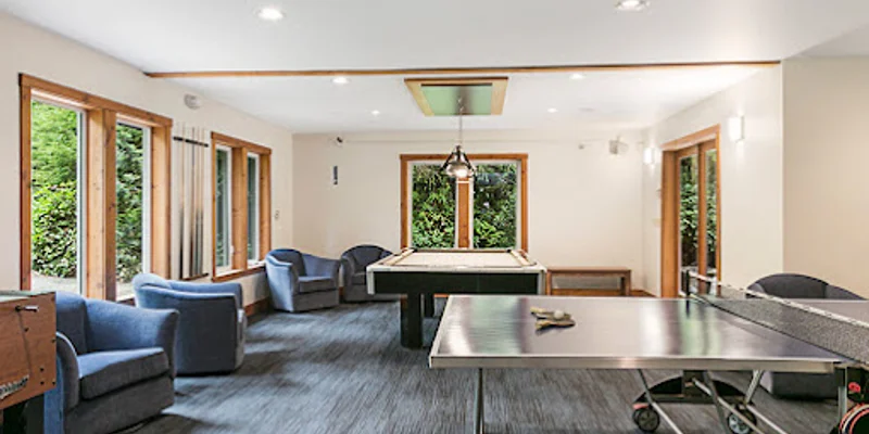 Game room with a pool table, table tennis, and seating.