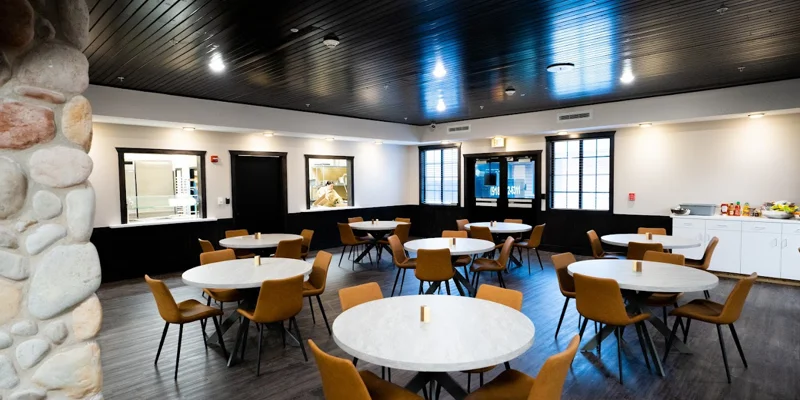 Rehab dining area with modern decor and round tables.
