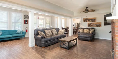 Lving space with sofas, a fireplace, and a TV.