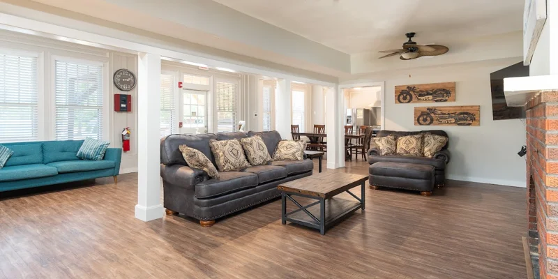 Lving space with sofas, a fireplace, and a TV.