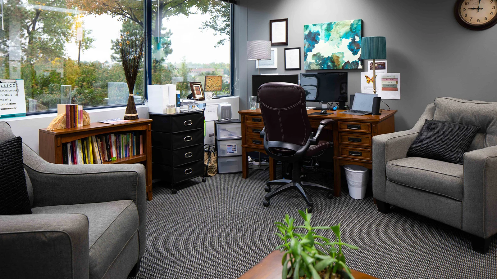 Therapy room with seating and a large window view.