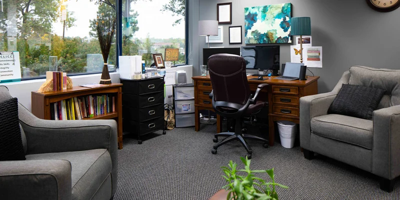 Therapy room with seating and a large window view.