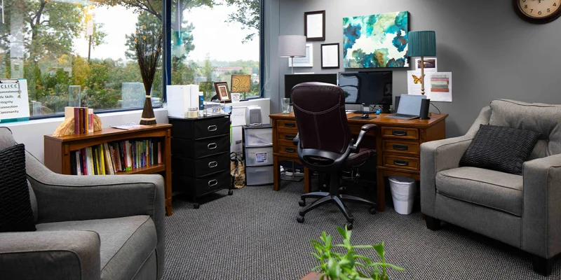 Therapy room with seating and a large window view.