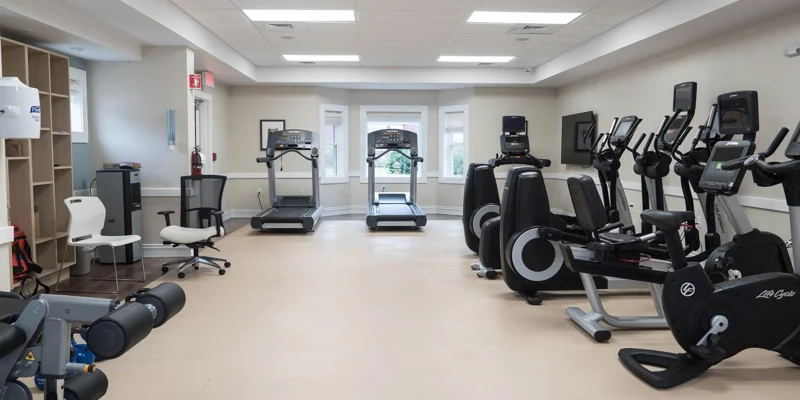 Gym with exercise machines and a TV.