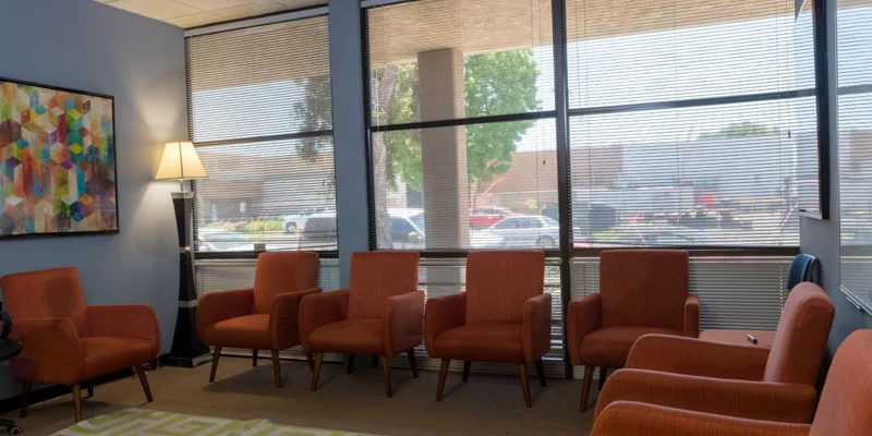 Waiting area with chairs along the wall.