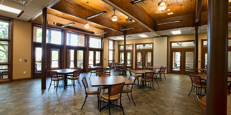 Spacious dining hall with wooden ceilings and large windows