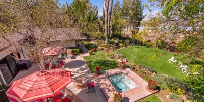 Facility backyard with a spa and seating.