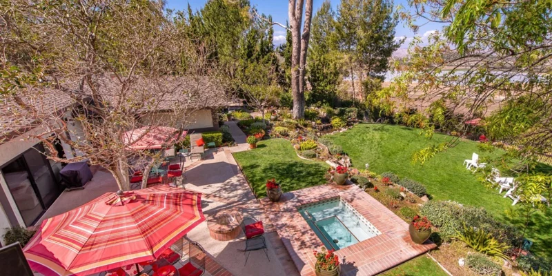 Facility backyard with a spa and seating.