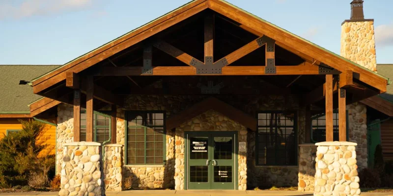 Close-up of rehab center entrance with wood and stone design.