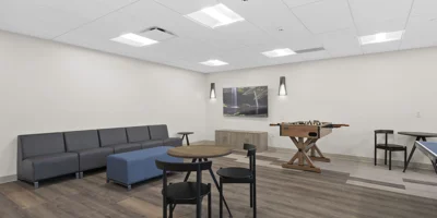 A lounge area with games, tables, and a foosball table.