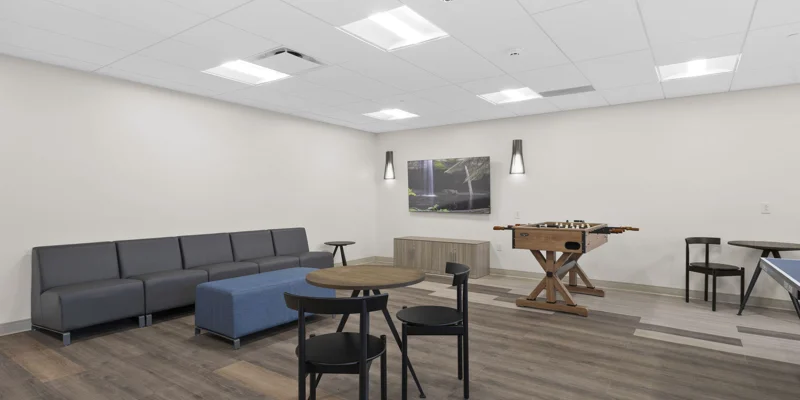 A lounge area with games, tables, and a foosball table.