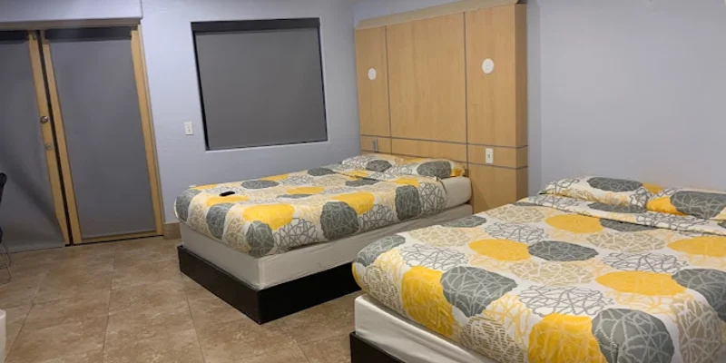 Clean bedroom with two beds and minimalist decor.