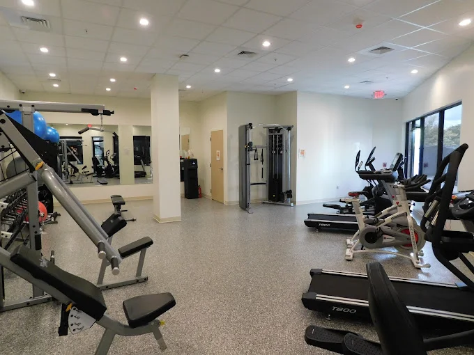 Gym with treadmills and weight machines.