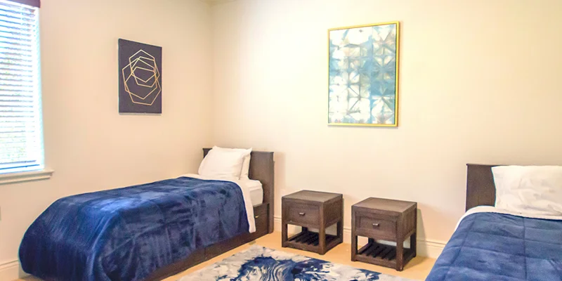 Bedroom with two beds and side tables.