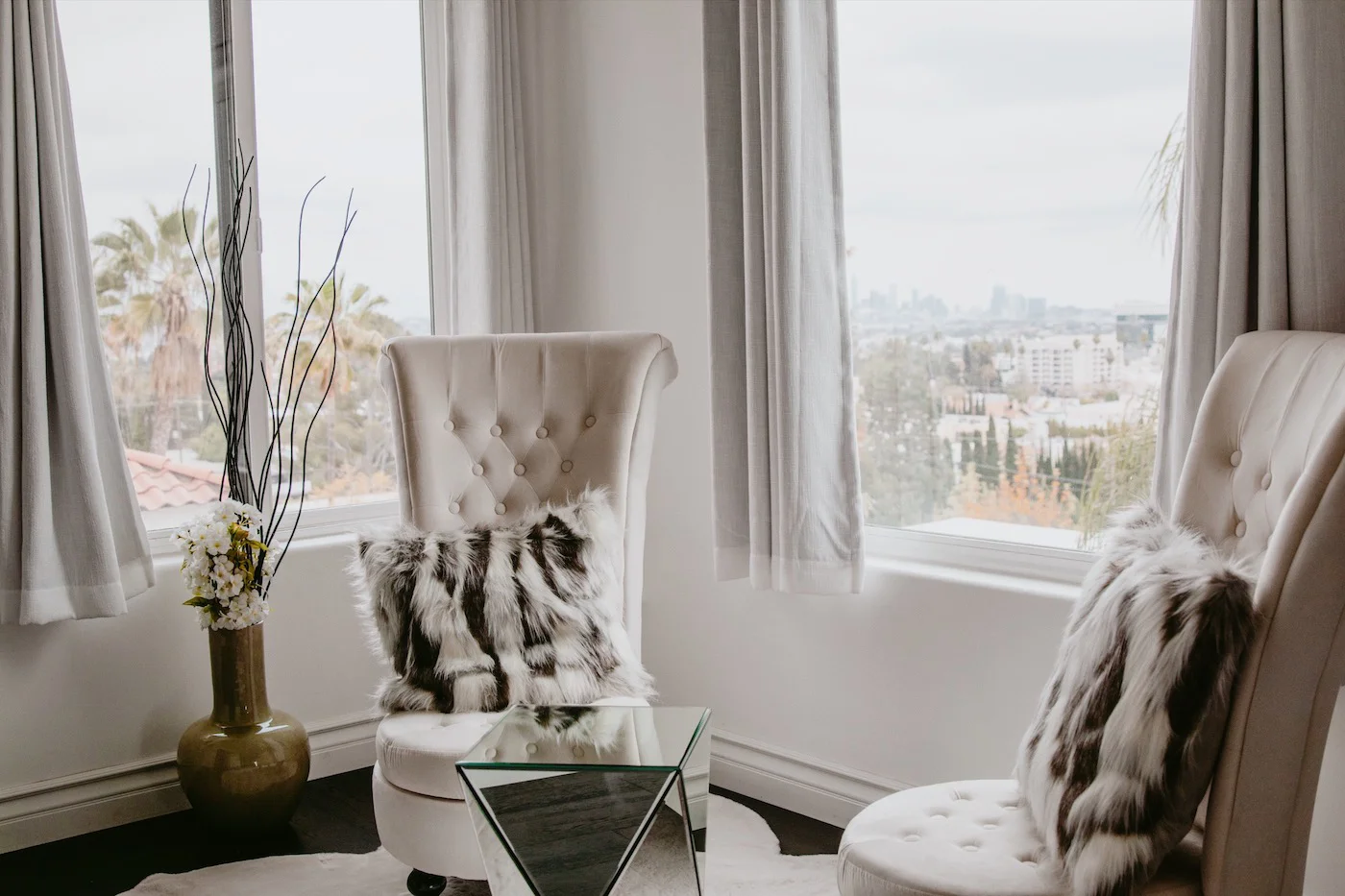 Sitting area with city views and high-back chairs