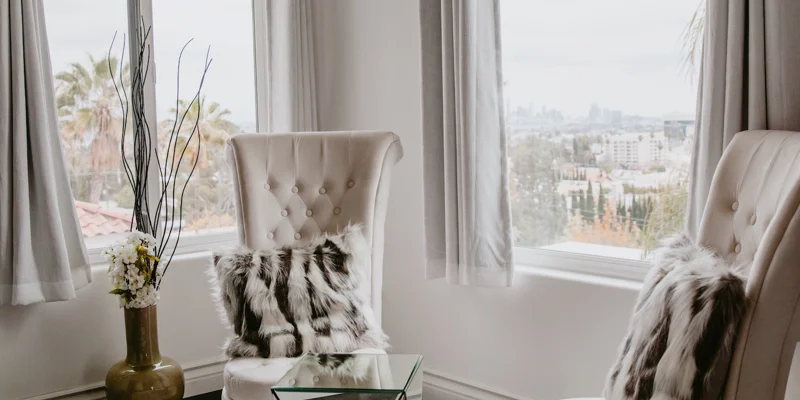 Sitting area with city views and high-back chairs