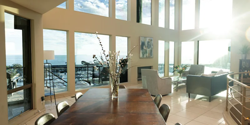 Dining area with large windows and seating.