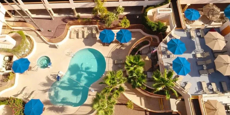  Aerial view of backyard pool area with lounge chairs.
