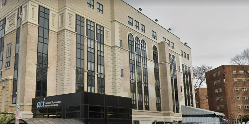  A building with tall windows and entrance signage.
