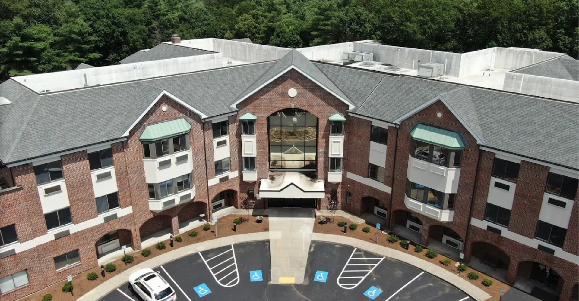 Aerial view of a large rehab facility with greenery.