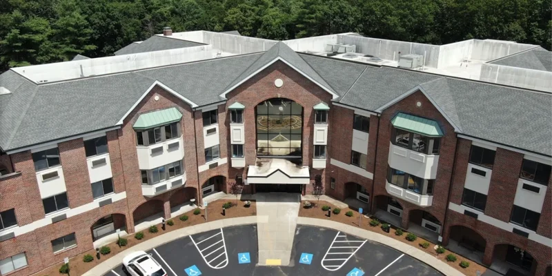 Aerial view of a large rehab facility with greenery.