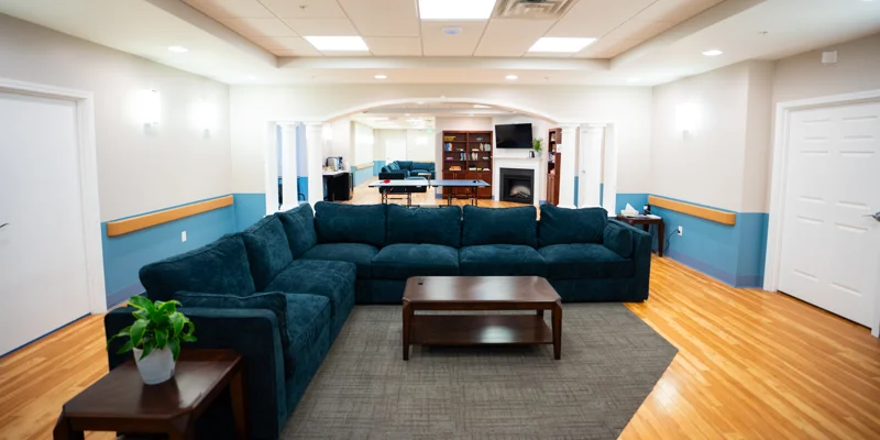 Lounge with large sectional sofa, fireplace, and ping pong table