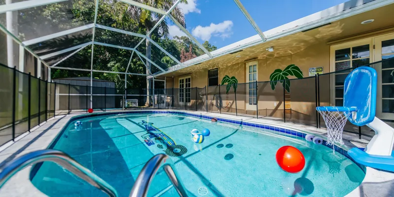 Enclosed pool with float toys and basketball hoop