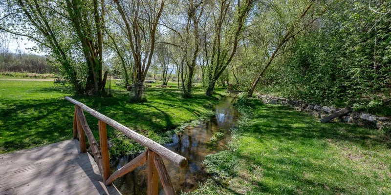 Outdoor area with a bridge over a stream.