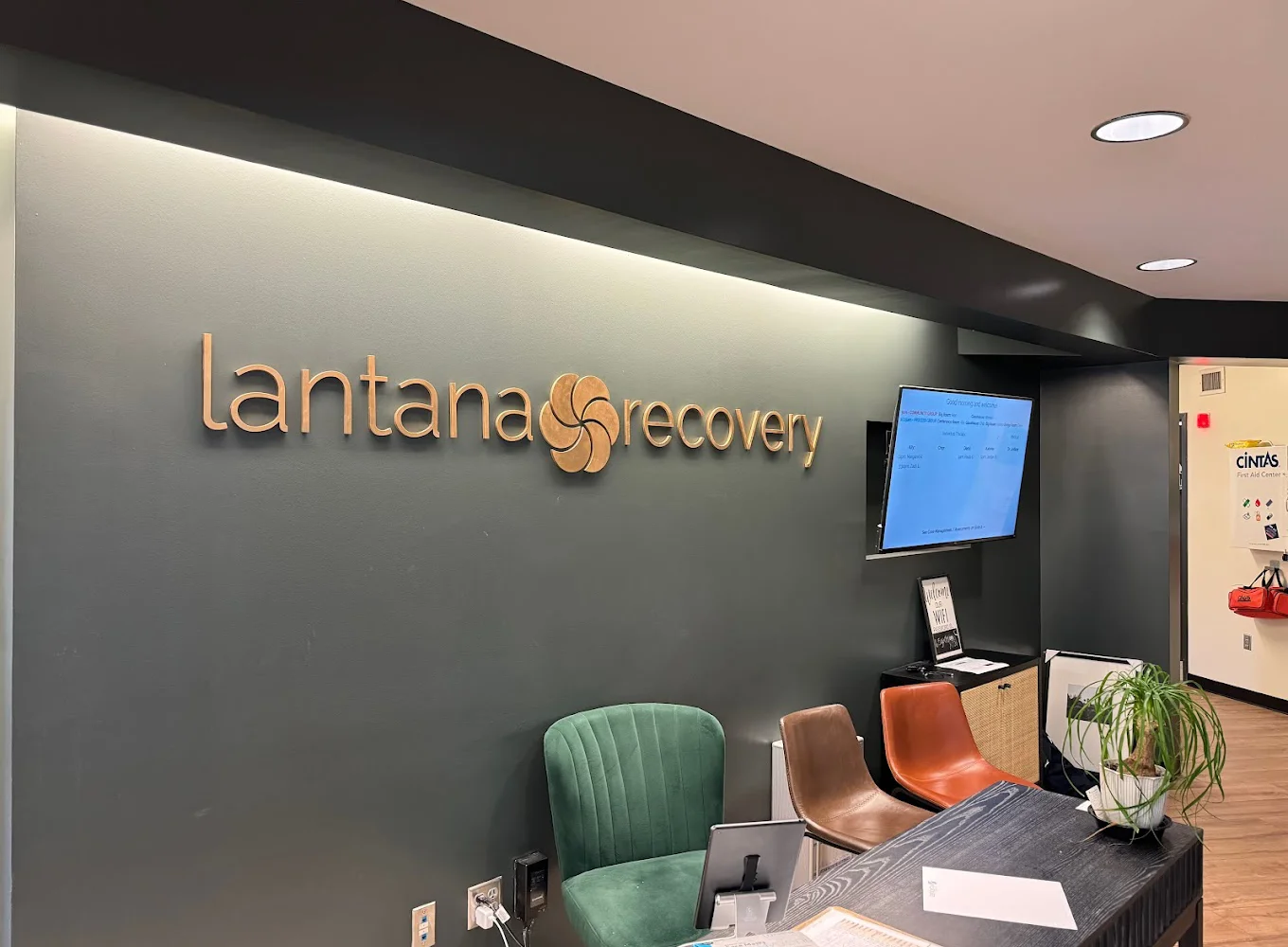 Lantana Recovery reception with a green accent wall and seating area.