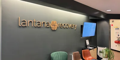 Lantana Recovery reception with a green accent wall and seating area.