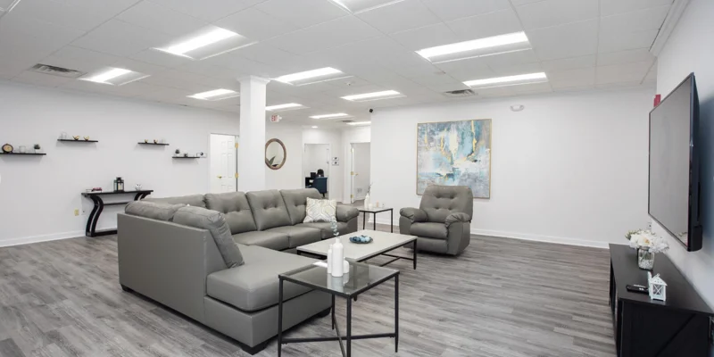 Lounge with couches and tables with a TV.
