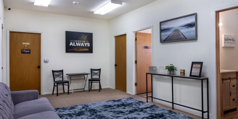 Lounge area with a couch, rug, and framed wall decor