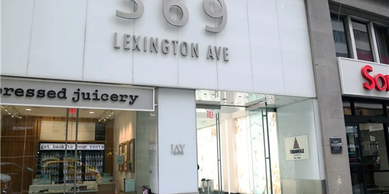 Glass entrance at 369 Lexington Ave with signage.