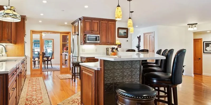 Open kitchen with a large island, and seating,