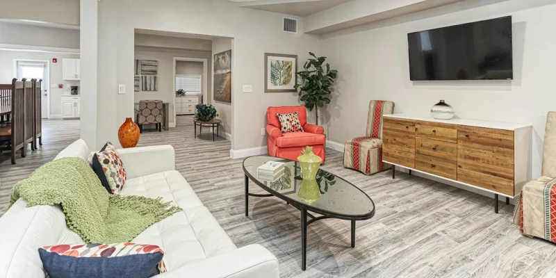 Rehab lounge with modern furniture and mounted TV