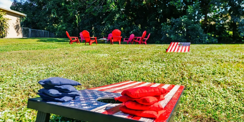 Red and blue beanbags on painted cornhole boards