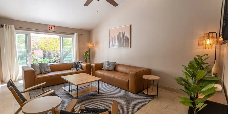 A cozy living area with leather sofas and wooden furniture.
