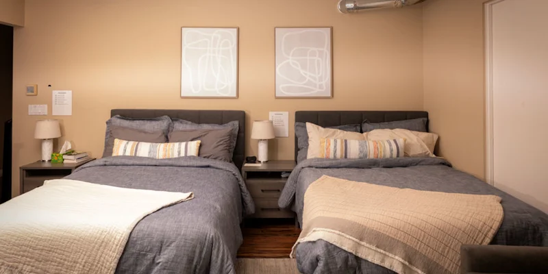 Bedroom with two beds and side-tables.