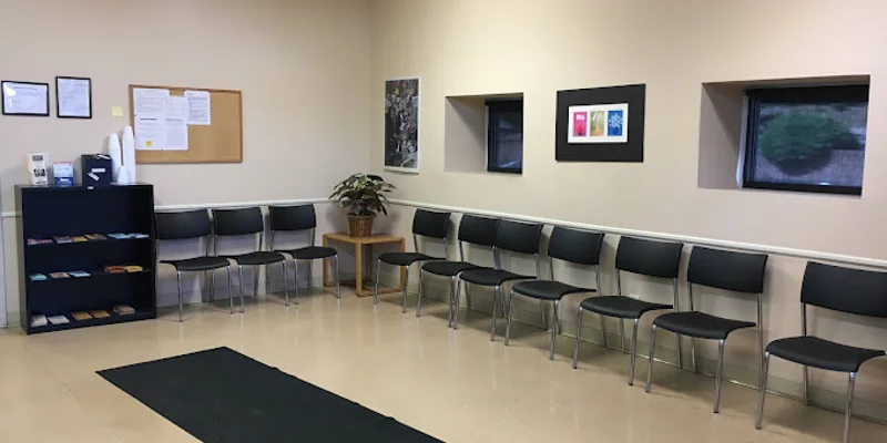 Waiting area with chairs, a bulletin board, and brochures.