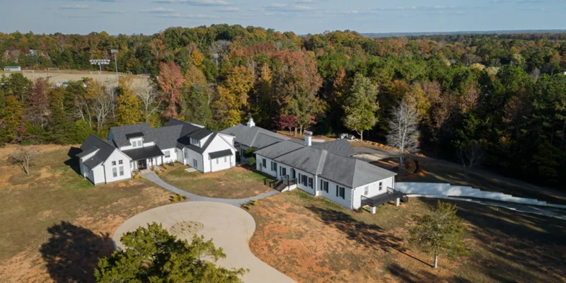 Aerial view of facility with driveway.
